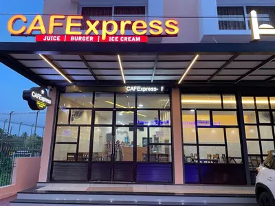 a coffee house with a sign that reads cafe express at Hotel Deepakam Inn in Palakkad