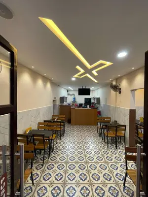 a dining room with tables and chairs in a restaurant at Hotel Deepakam Inn in Palakkad