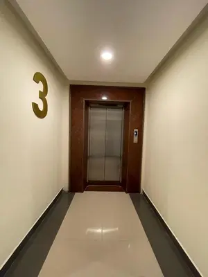 an empty hallway with a number on the wall at Hotel Deepakam Inn in Palakkad