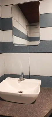 a white sink in a bathroom with a mirror at Angels Nest Home stay 2 Acra private plantation Mountain area balconey SunRice view Nearby Ngarhole wild life , Tholpetty wild life , Pakshipathalam Bird santuary , Kuruva island # Thirunelly & Thrissilery Temple Near by Secure Stay Wayanad Kerala in Chekadi
