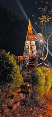 a house with a staircase in front of it at Angels Nest Home stay 2 Acra private plantation Mountain area balconey SunRice view Nearby Ngarhole wild life , Tholpetty wild life , Pakshipathalam Bird santuary , Kuruva island # Thirunelly & Thrissilery Temple Near by Secure Stay Wayanad Kerala in Chekadi