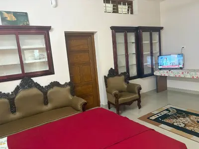 a living room with a couch and chairs and a tv at Guruvayur Homestay - 2 AC Bedrooms, Hall & Veranda in Guruvāyūr
