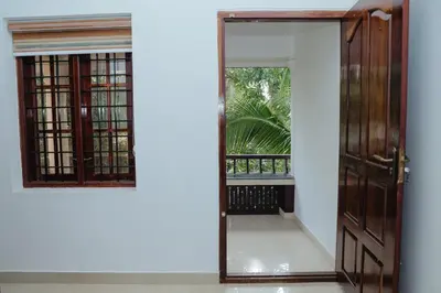 an open door with a mirror and a balcony at Sankalpa Homestay in North Paravur