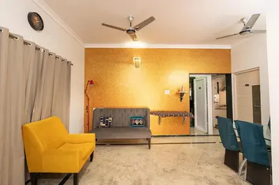 a living room with a couch and chairs at Hive Service Apartment in Coimbatore