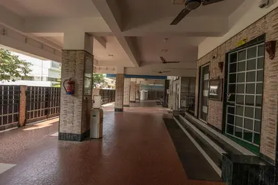an empty hallway of a building with brick walls at Hive Service Apartment in Coimbatore