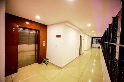 a hallway of a building with a elevator at Airport Avenue Plaza in Nedumbassery