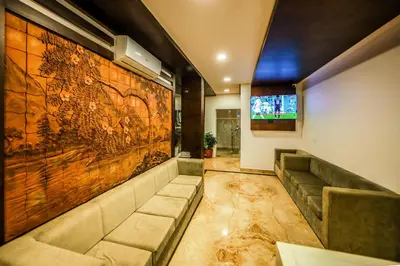 a lobby with a large painting on the wall at Airport Avenue Plaza in Nedumbassery