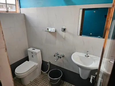 a bathroom with a toilet and a sink at Hamsted in Kottakkal