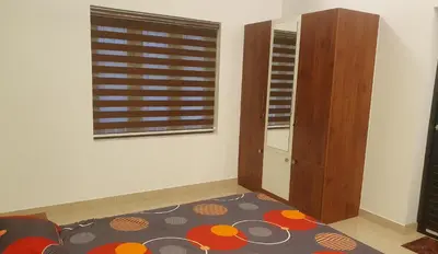 a living room with a window and a rug at Homestay- Near to Cochin Airport in Kāladi