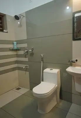 a bathroom with a toilet and a sink at Homestay- Near to Cochin Airport in Kāladi