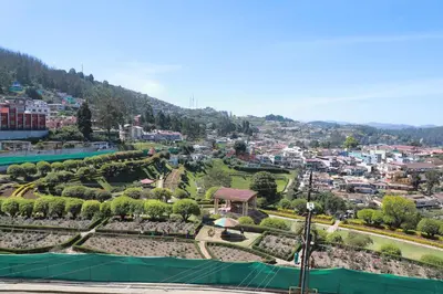 a view of a park with a city in the background at The Woodlands Residency- Unmarried and stag groups not allowed in Ooty