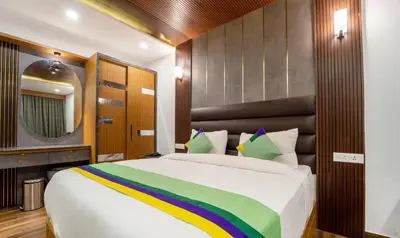 a bedroom with a large bed with a colorful blanket at Treebo Skydale Premium Suites, 1500 Mtrs From Ooty Lake in Ooty