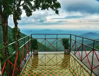 a balcony with a view of the mountains at Vayalada View Point Resort in Kozhikode