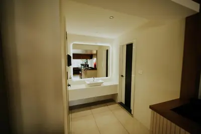 a bathroom with a sink and a mirror at Hotel Bluebell in Kozhikode
