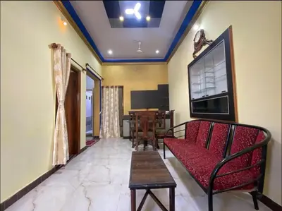 a living room with a couch and a table at The bluebird residence in Mysore