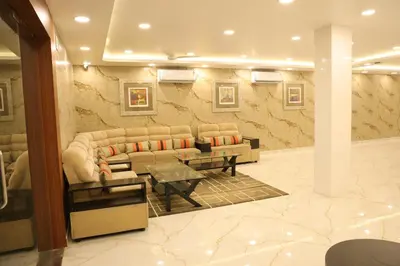 a lobby with couches and a table in a room at HOTEL SR in Palani
