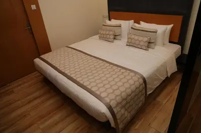 a bedroom with a large bed with pillows at HOTEL SR in Palani