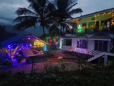 a house decorated for christmas with lights on it at Paradise Homestays, Kanthalloor in Kanthalloor
