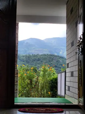 a room with a window with a view of a mountain at Paradise Homestays, Kanthalloor in Kanthalloor