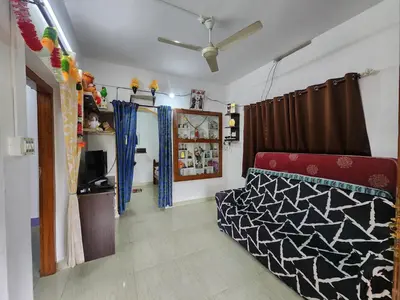 a living room with a couch and a television at Paradise Homestays, Kanthalloor in Kanthalloor