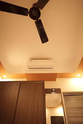 a ceiling fan in a living room with at Kovilakam Achutham in Guruvāyūr