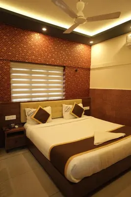 a bedroom with a large bed in a room at Kovilakam Achutham in Guruvāyūr