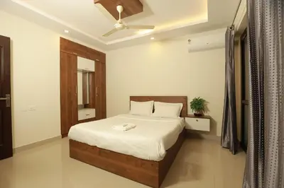 a bedroom with a bed and a ceiling fan at Platinum Airport Lounge by VVP in Nedumbassery