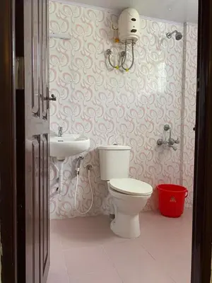 a bathroom with a toilet and a sink at Platinum Airport Lounge by VVP in Nedumbassery