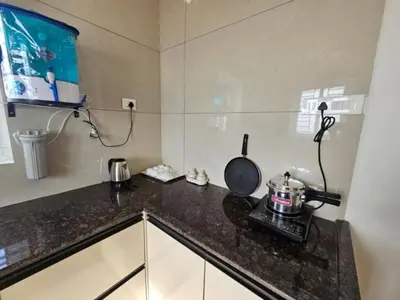 a kitchen with a counter top with a pan on it at Thulasi Avenue Inn in Pollāchi