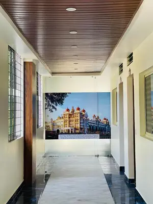a hallway with a painting of a building at Hotel Boss Palace in Mysore