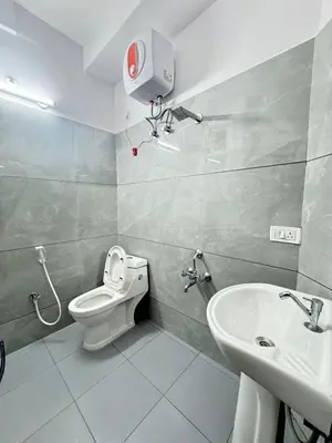 a bathroom with a toilet and a sink at Hotel Boss Palace in Mysore
