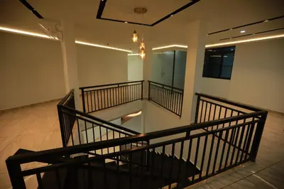 an empty room with a staircase in a building at Premier Tourist Home in Kunnamkulam