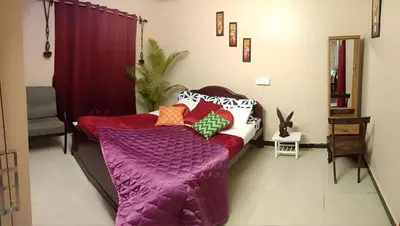 a living room with a couch with pillows on it at Silver Spruce 2BHK Entire Floor Kotagiri in Kotagiri