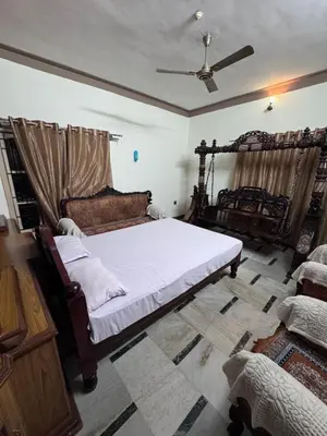 a bedroom with a bed and a ceiling at NAS VILLA in Mysore