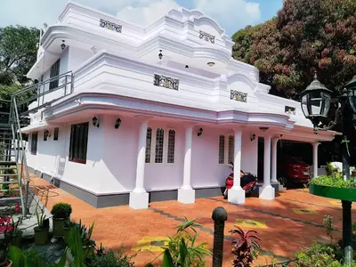 a white house with a pink at COZY Homes in Nedumbassery
