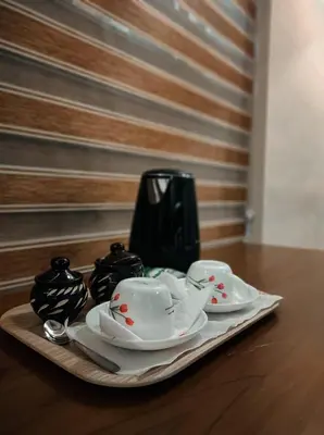a tray with plates and cups on a table at ATHIRAPPILY SREENILAYAM HERITAGE RESORt in Athirappilly