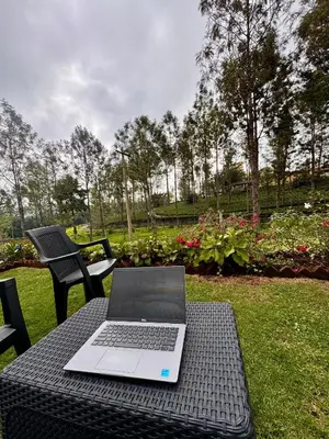 a laptop computer sitting on top of a table at Tranquil Haven Kotagiri in Kotagiri