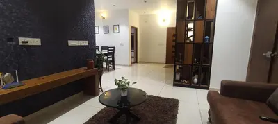 a living room with a table and a couch at Mountain View Villa in Mukkam