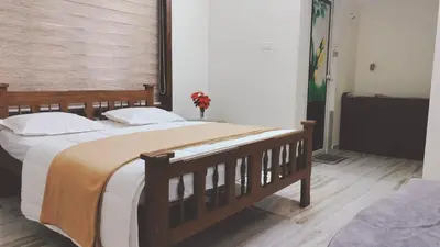 a bedroom with a large bed in a room at UPPU HOMESTAY in Mulappilangād