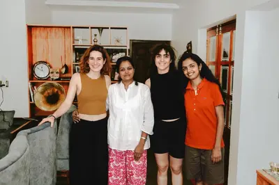 a group of women standing in a living room at Ananda Holiday Home in Ambalavayal