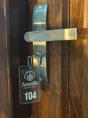 a lock on a door with a sign on it at Ananda Holiday Home in Ambalavayal