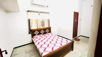 a small bedroom with a bed in a room at White House - 2BHK - Esha Apartment in Coimbatore