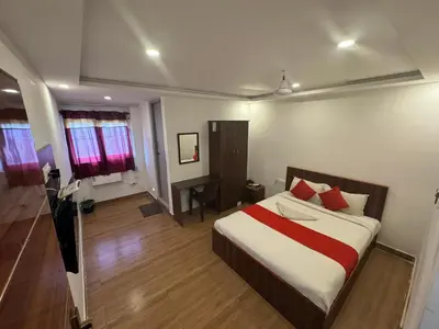 a bedroom with a bed and a desk in it at Hotel New Cresent park in Coimbatore