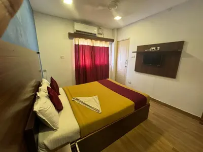 a hotel room with a bed with a napkin on it at Hotel New Cresent park in Coimbatore