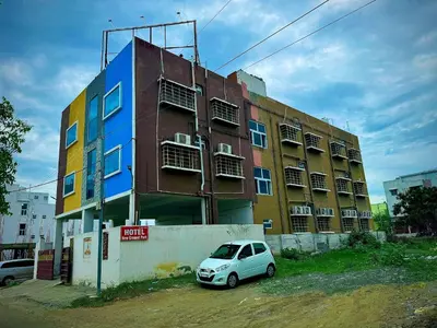 a small car parked in front of a building at Hotel New Cresent park in Coimbatore