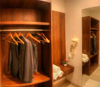 a walk in closet with a robe at THE DAWN HOTEL in Mysore