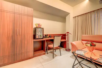 a living room with a desk and a chair at Hotel Hari Govindas Mysore - Explore the Heart of Mysore in Mysore