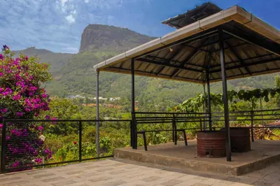 a pavilion with a view of a mountain at Blue Lake in Kanthalloor
