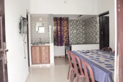 a room with a table and chairs and a door at Blue Lake in Kanthalloor