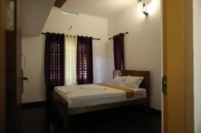 a small bedroom with a bed with curtains at Le Serene in Meenangadi